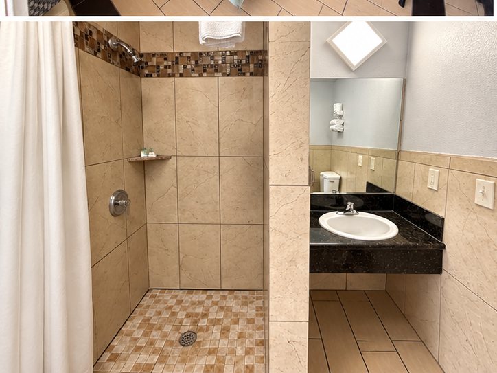 Tiled bathroom with a roll-in walk-in shower and vanity