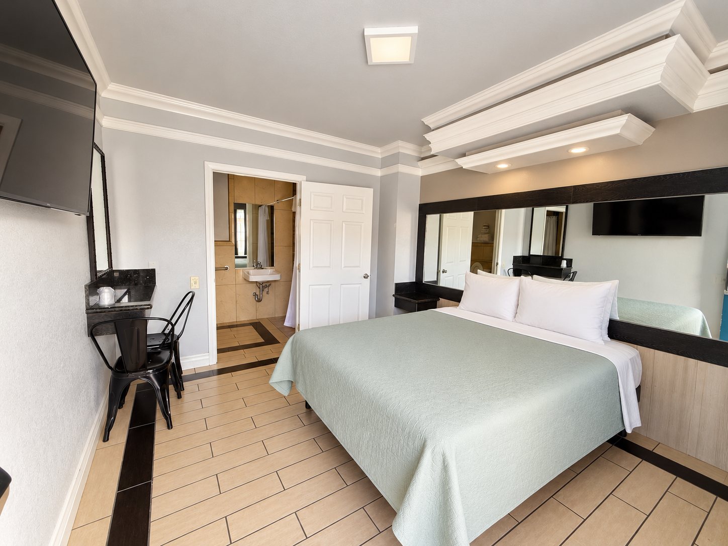 The accessible room, showing the bed, the tiled step-free floor and the widened bathroom doorway.